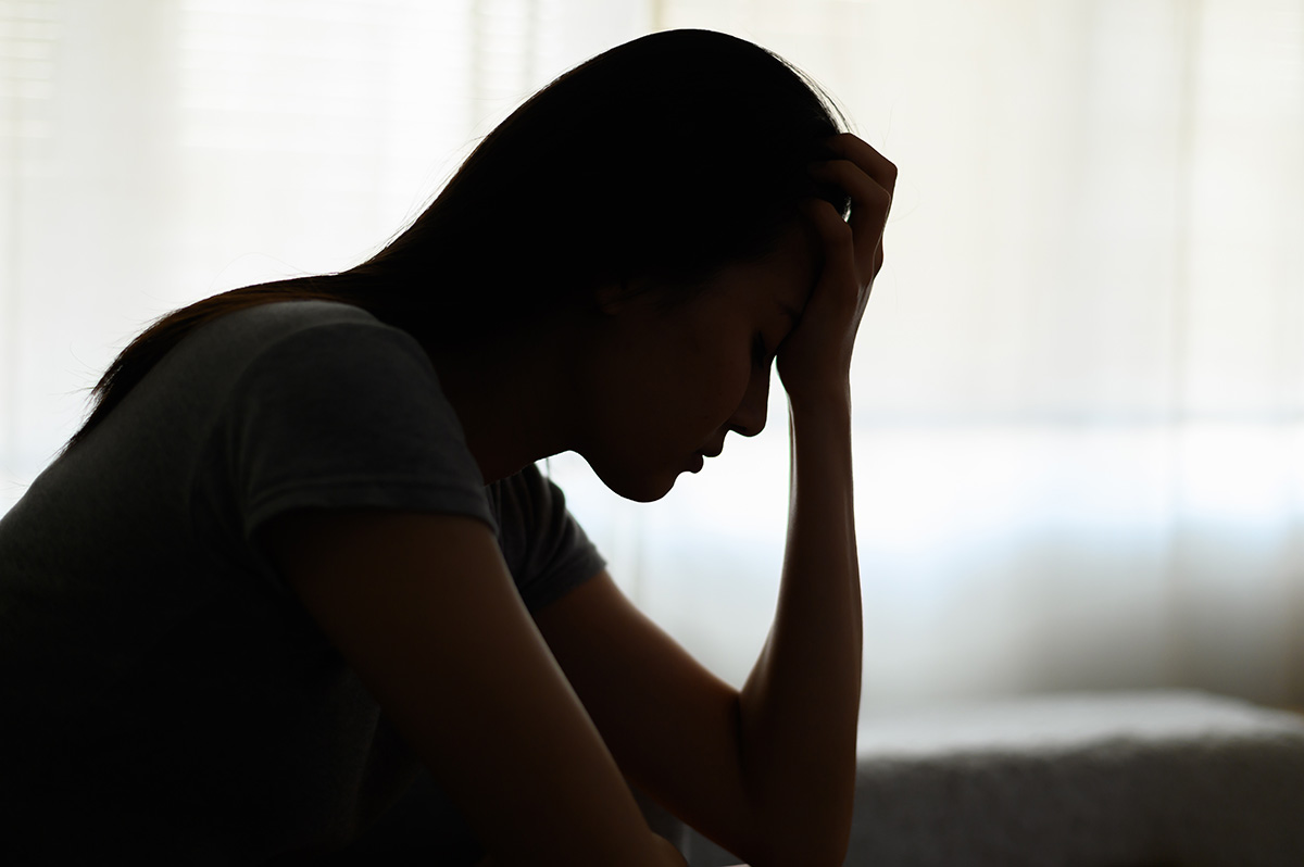 A woman thinking about the Florida opioid crisis