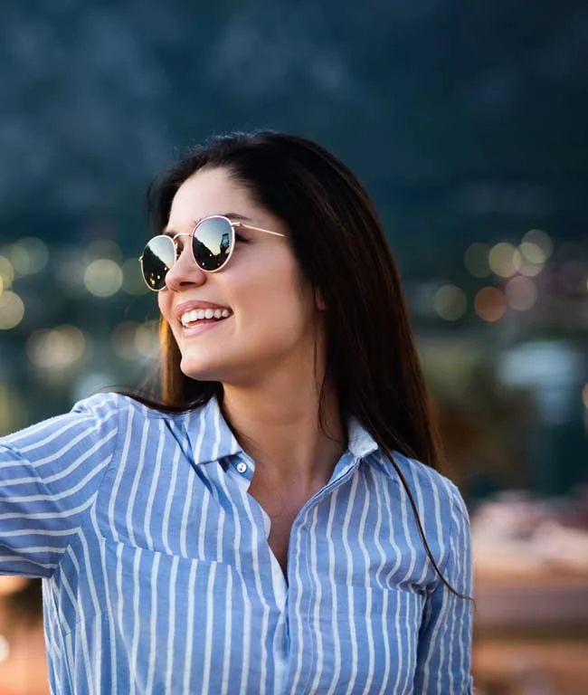 image of a happy woman around the holidays for article on staying happy through the holidays without relapse for Gulf Breeze Recovery