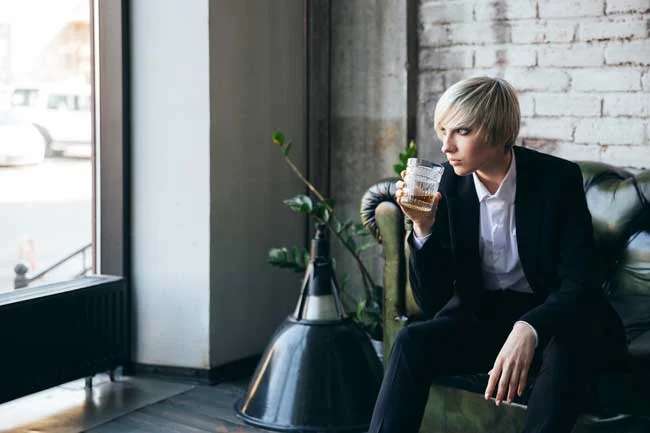 image of stylish young woman drinking alone