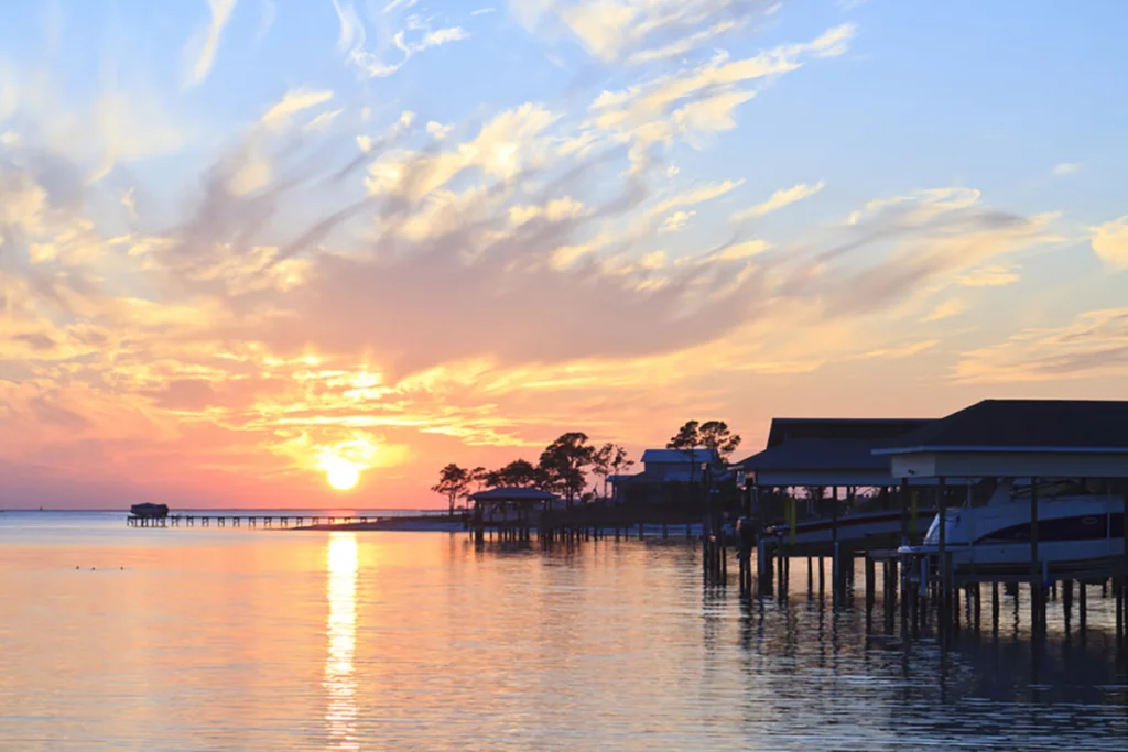 Dock on water during sunset