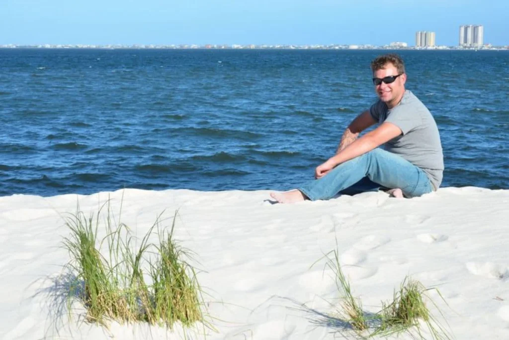 Man in sunglasses relaxing on beach