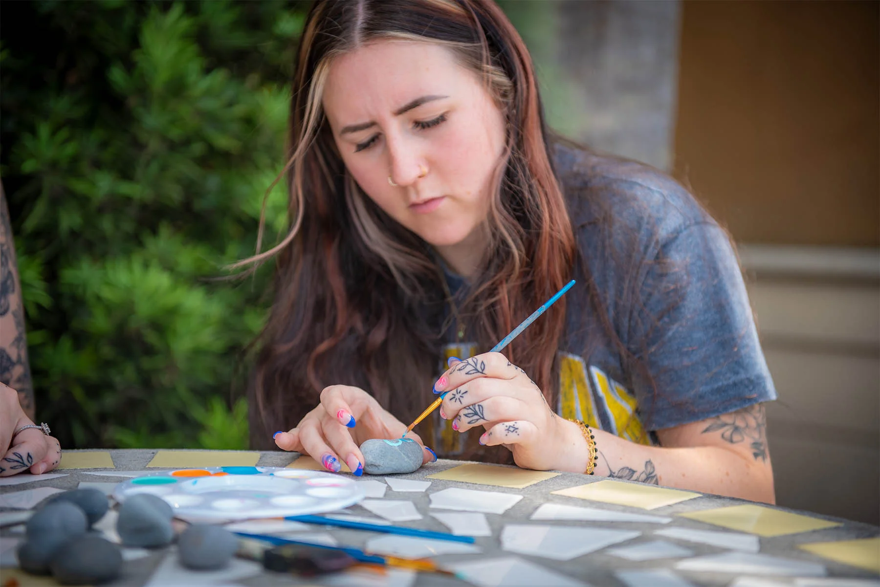 Woman painting rock art therapy