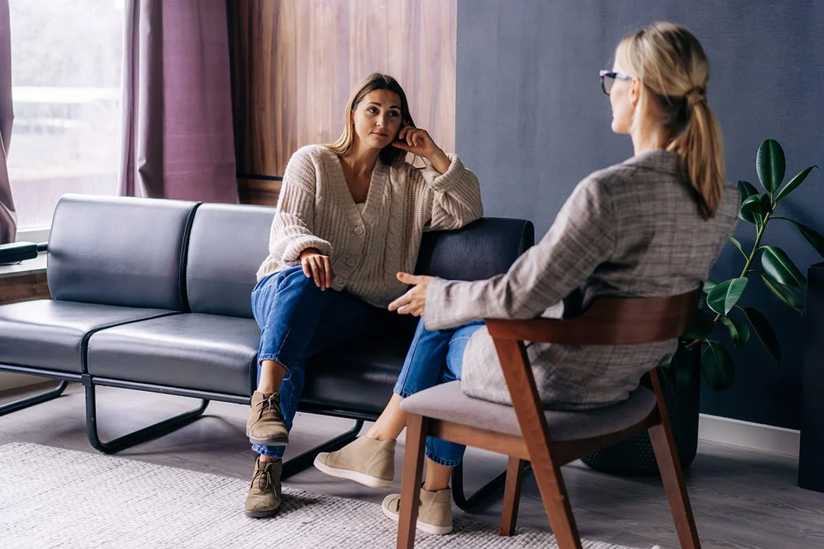 woman discussing depression treatment benefits with compassionate counselor