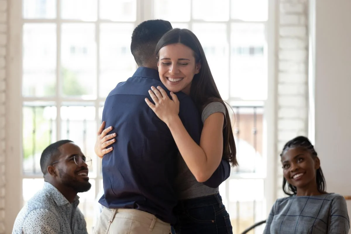 Happy person in session with counselor after getting sober and participating in aftercare treatment|aftercare treatment