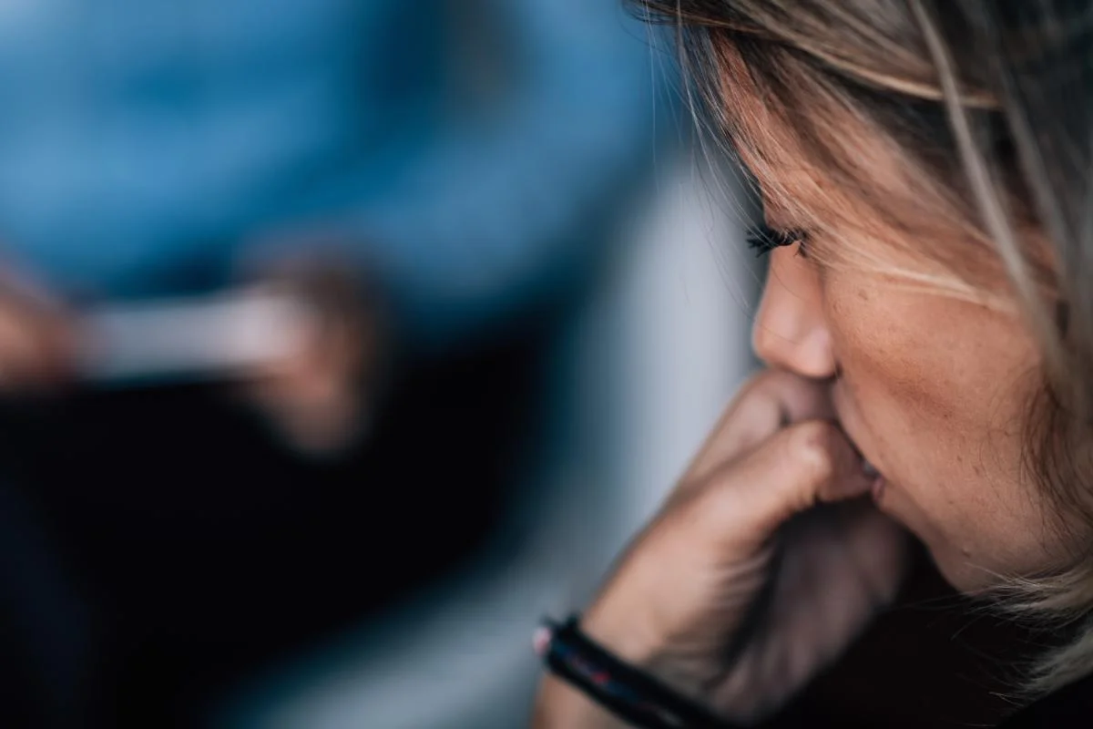 a woman debates getting EMDR therapy for trauma