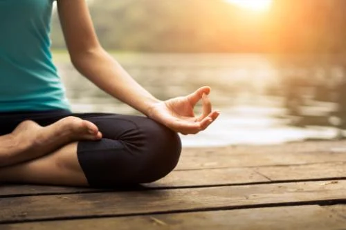 a woman participates in a meditation therapy program in program