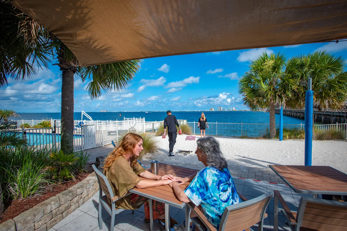 People sitting at table near the beach