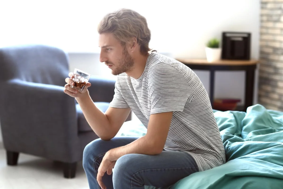 Person drinking caffeine mixed with alcohol