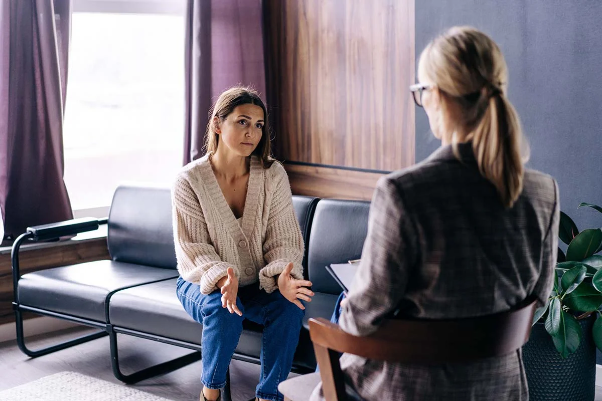 Concerned client and counselor discussing treatments for opioid addiction
