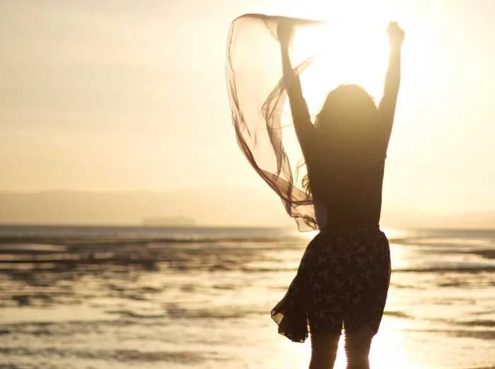 image of a woman with arms outstretched in an expression of hope in front of a dramatic sunset on the beach in florida for a blog article entitled What can I do if AA didn’t work? for Gulf Breeze Recovery drug and alcohol treatment holistic THRIVE® Total Health Recovery